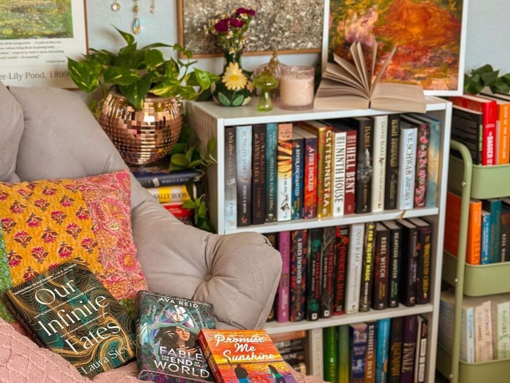 Cozy BookTok-inspired reading nook with fairy lights, floating bookshelves, papasan chair with throw blanket and pillows, and a wall of colorful books.